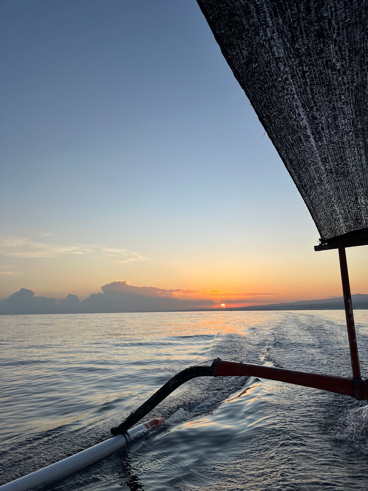 Sunset from a traditional outrigger boat in Bali
